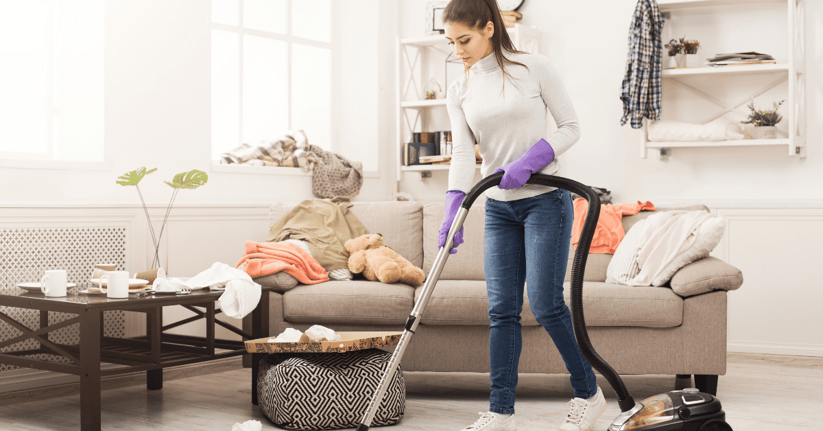 Deep cleaning - a young lady uses a vacuum cleaner